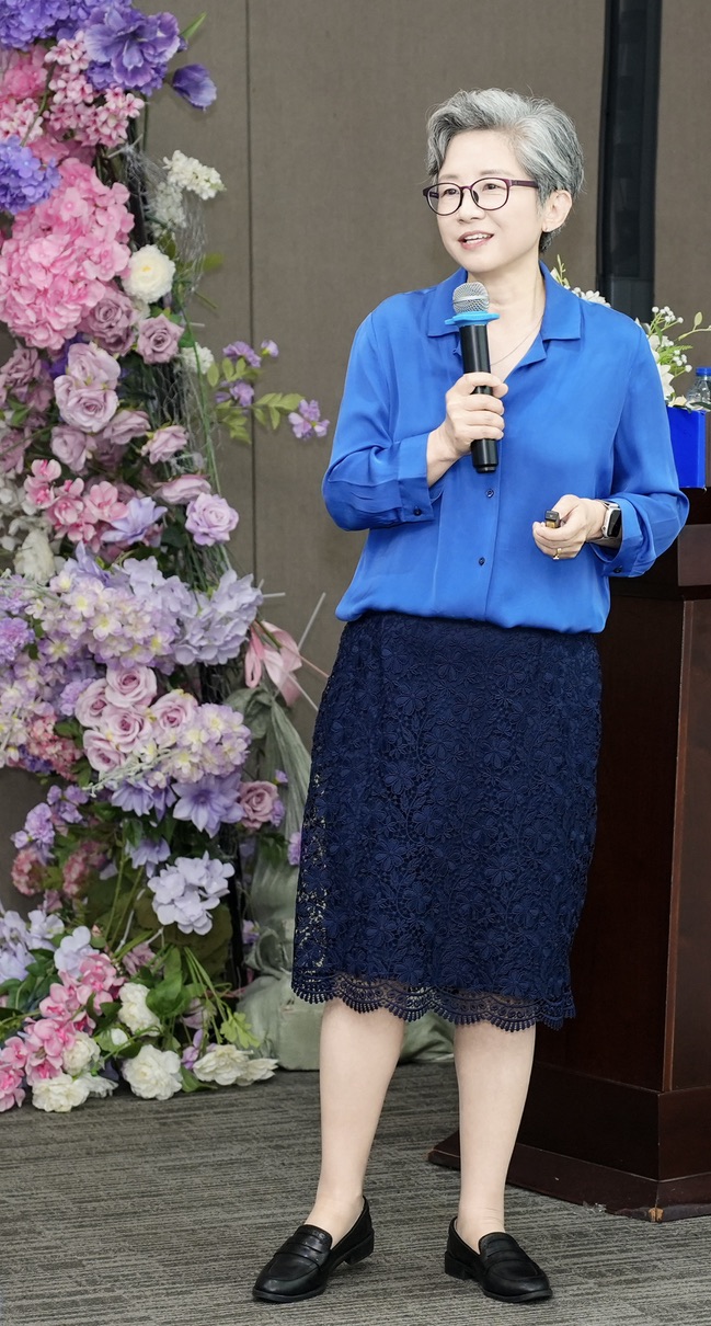 Dr. Ferguson speaking with a handheld microphone